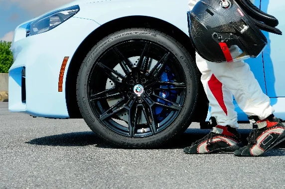 Continental performance tire on BMW with race driver