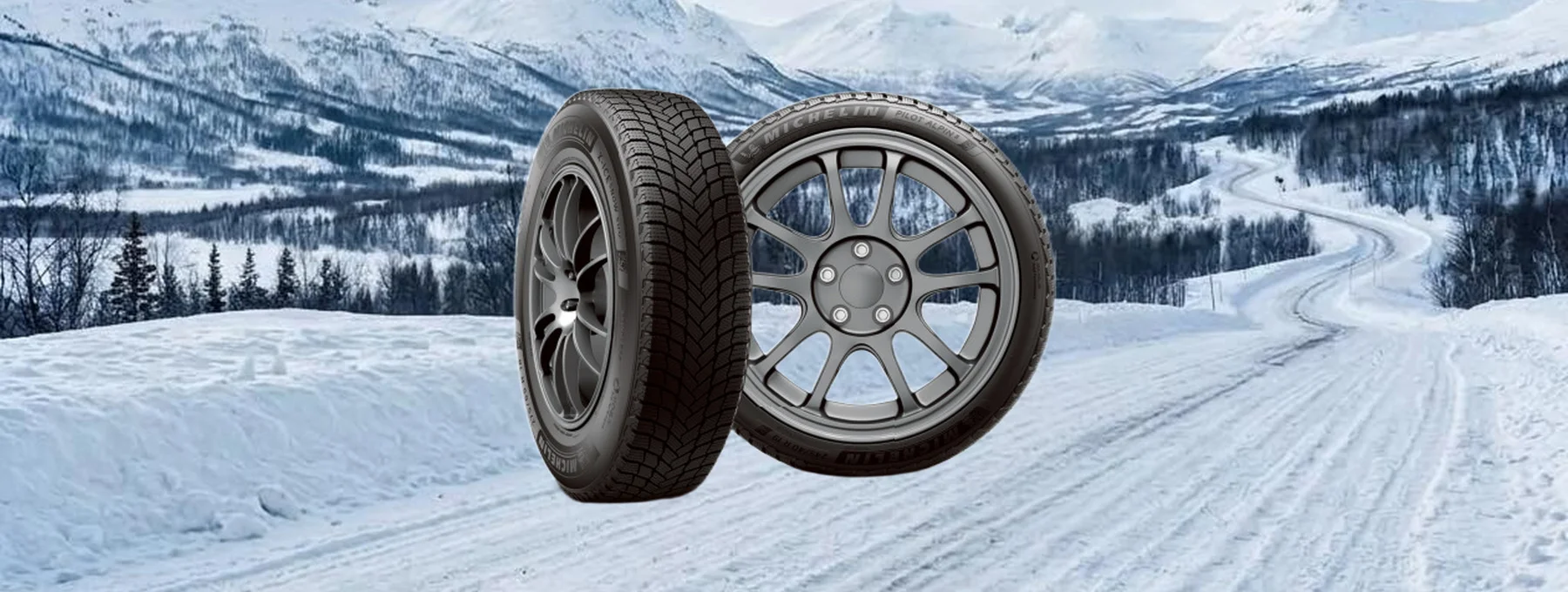Two Michelin winter tires on a snowy mountain road