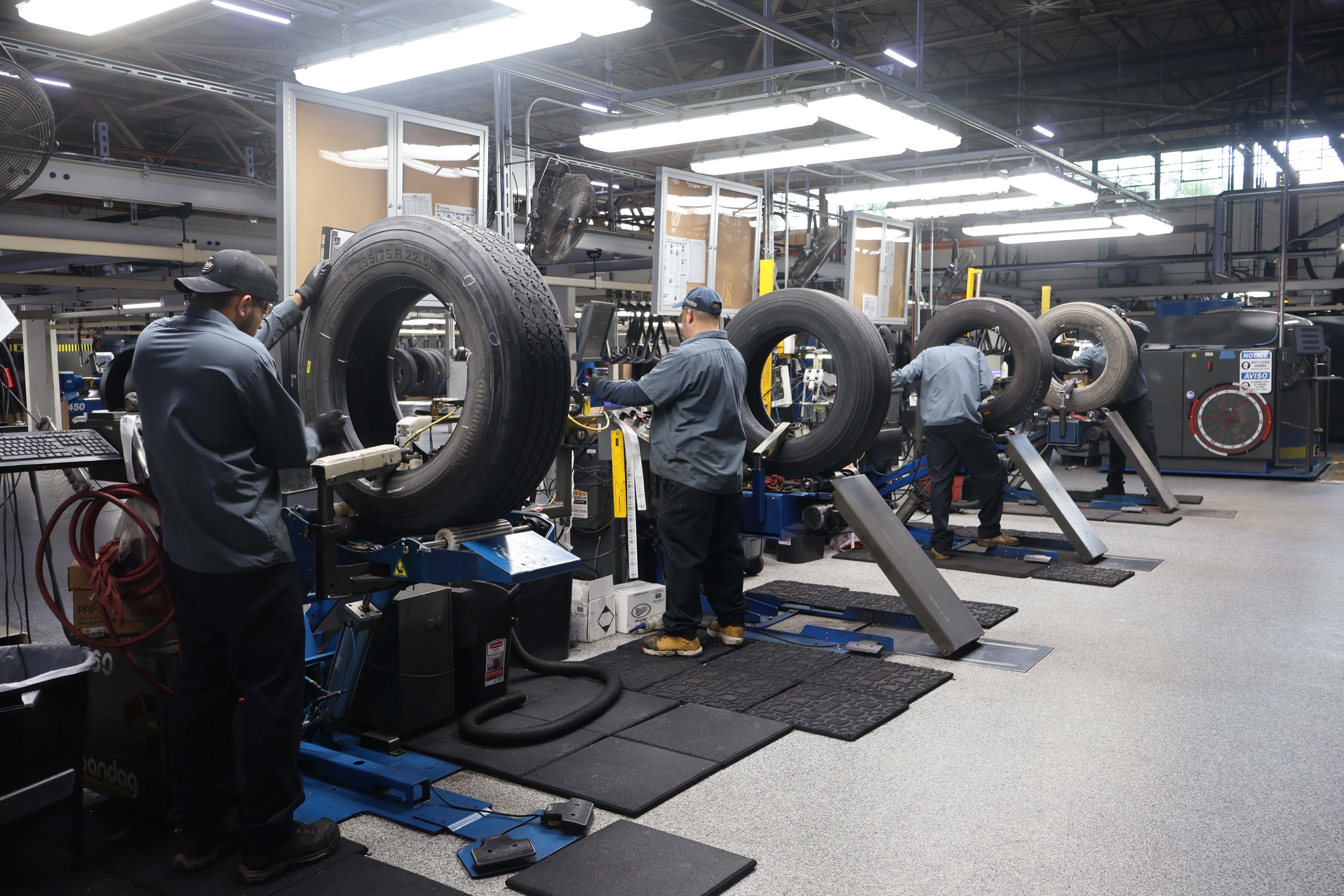 Technicians servicing tires at Pomp's Waukegan retread facility